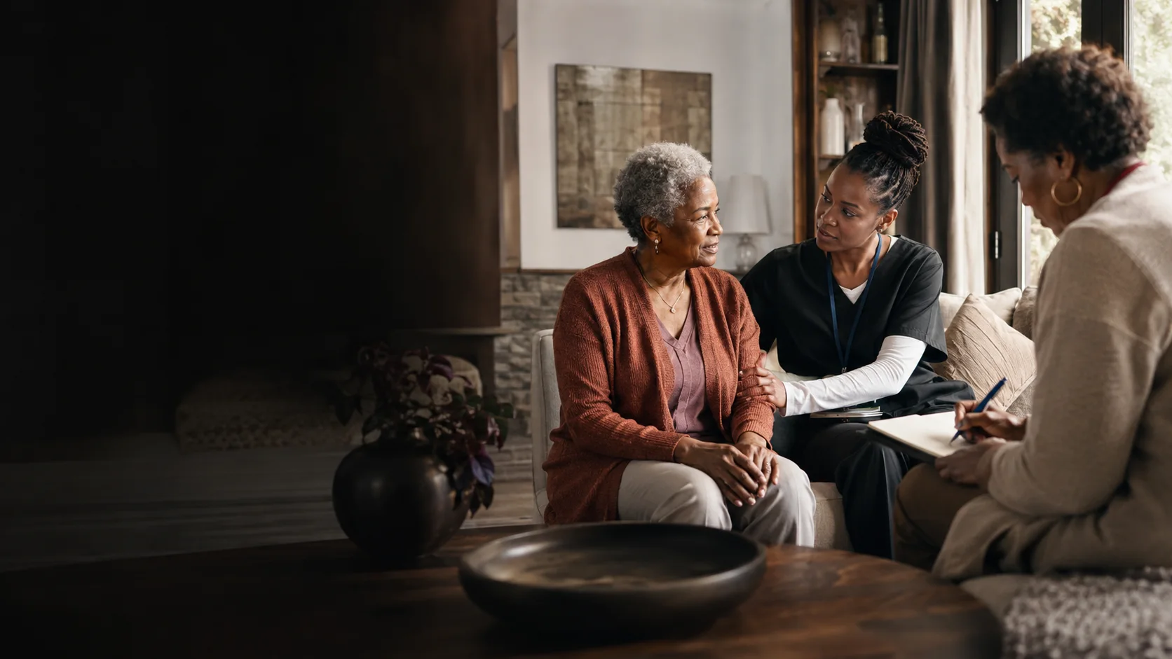 A home-care professional speaking with a client